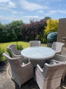 a patio with a table and wicker chairs at Prospect Beach House 2, Portstewart in Portstewart