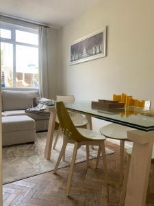 a living room with a table and a couch at Prospect Beach House 2, Portstewart in Portstewart