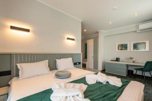 a bedroom with a large white bed with a sink at d'Eric Mamaia Nord in Mamaia Sat/Năvodari