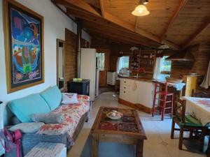 a living room with a couch and a table at Cabañas Ananda in Villa Ventana