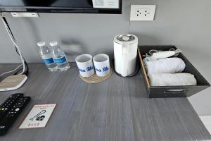 a desk with a tray of towels and water bottles at Casa Blu Hotel & Resort in Maribago