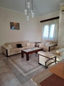 a living room with a couch and a table at Val's place in Mytilene