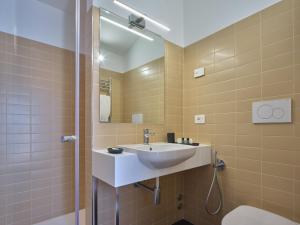 a bathroom with a sink and a shower at Portica Homes Assisi in Assisi +32 photos