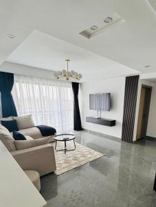 a living room with a couch and a table at Riverside Lux condo in Nairobi +38 photos