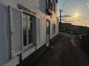 a building with windows on the side of it at Sunrise In Lomba AL 5089 in Lomba