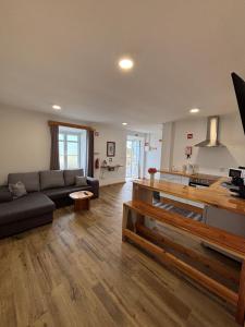a living room with a couch and a kitchen at Sunrise In Lomba AL 5089 in Lomba