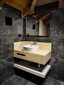 a bathroom with a sink and a mirror at Palorto Inn in Gjirokastër +134 photos
