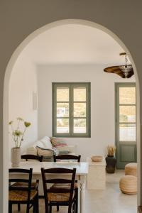a living room with a table and chairs at VERANNA Patmos in Patmos