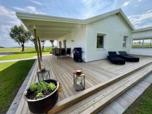 a wooden deck with a house at Huset på landet i Falkenberg in Heberg +32 photos