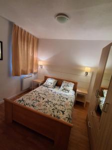a bedroom with a bed with two pillows on it at Les Portes d'honfleur in Boulleville +13 photos