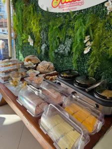 a table with a buffet of food on it at Pousada La Acolhida in Cabo Frio +38 photos