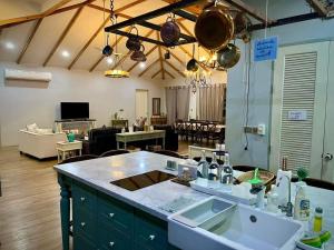 a kitchen and living room with a kitchen and a living room at Brook Villa Khaoyai in Pak Chong