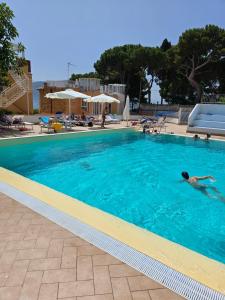 a person swimming in a swimming pool at Chris House Mondello in Palermo