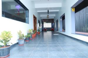 an empty hallway with potted plants in a building at Bio Villas Resorts in Yelagiri