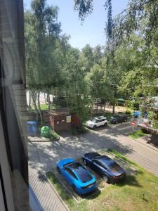 a view of two cars parked in a parking lot at Apartament Polanki E207 in Kołobrzeg