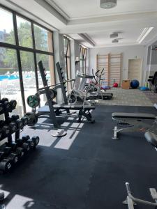 a gym with a bunch of equipment in a room at Apartament Polanki E207 in Kołobrzeg