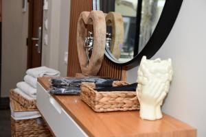 a table with a purse and a mirror and towels at Luna Mare Boutique Seaside in Borsh
