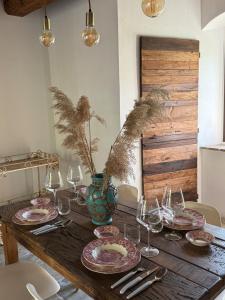 a wooden table with plates and wine glasses on it at Il Fienile di Bisarno in Pontassieve +37 photos