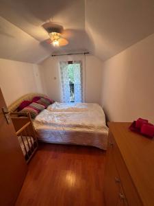 a bedroom with a large bed and a window at Nature house Semizovac in Crnjevac