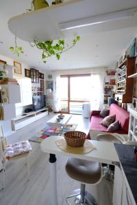a living room with a table and a couch at La Casa di Sole by PortofinoVacanze in Rapallo