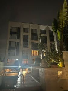 a building at night with a bench in front of it at Tsavo apartment in Nairobi