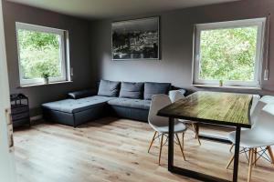 a living room with a couch and a table at Proud-Apartments Gießen in Gießen