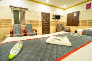 Postel nebo postele na pokoji v ubytování Sri Vinayaga Residency