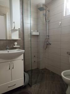 a bathroom with a shower and a sink and a toilet at Open Sky Montenegro in Utjeha +31 photos