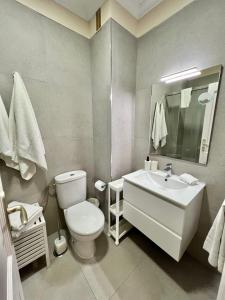 ein Badezimmer mit einer weißen Toilette und einem Waschbecken in der Unterkunft Apartamento incleibles vistas al océano y piscina. in Acantilado de los Gigantes