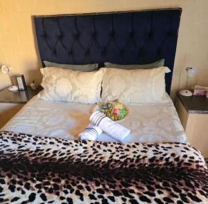 a bed with a stuffed animal laying on it at Mercy's Getaway Place in Cape Town