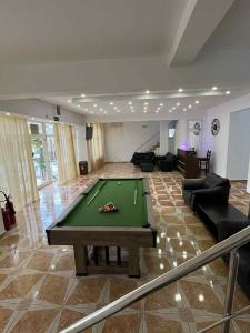 a living room with a pool table in the middle at Will House in Mamaia Nord