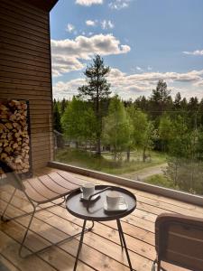 a balcony with a table and two cups on it at Villa Primus in Ruka