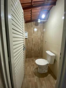 a bathroom with a toilet and a light on the ceiling at Rancho Pé de Serra in Manhã +12 photos