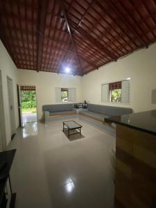a living room with a couch and a table at Rancho Pé de Serra in Manhã