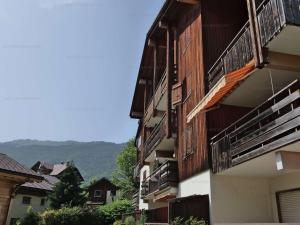 a building with balconies on the side of it at Charmant T2 + cabine, 6 pers, garage, près des stations La Clusaz et Le Grand-Bornand - FR-1-458-94 in Saint-Jean-de-Sixt