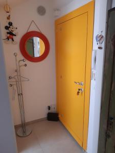 a yellow door in a room with a mirror at La Mansarda delle Mongolfiere in Turin