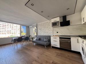 a kitchen with a table and chairs in a room at Sweet Holiday by luca properties grancanaria in Playa del Ingles