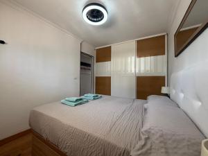 a bedroom with a bed with two towels on it at Sweet Holiday by luca properties grancanaria in Playa del Ingles