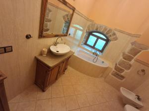 a bathroom with a sink and a tub and a mirror at Pałac Książęcy we Wleniu in Wleń +24 photos