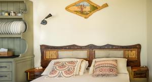 a bedroom with a wooden bed with two pillows at Artsy Wooden Cottage in Ratzaklíon
