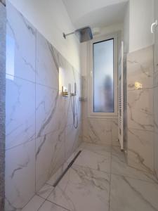 a white bathroom with a shower and a window at Belvedere 237A Lakeview Luxury Apartment in Ghiffa +37 photos
