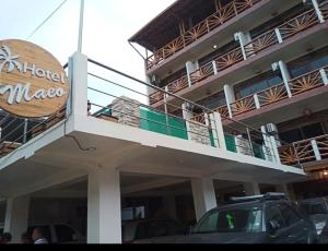 a building with a sign on the side of it at Hotel Maeo Suites in Montañita