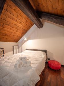 a bedroom with a large white bed with wooden ceilings at Appartamento nel cuore di Torino in Turin