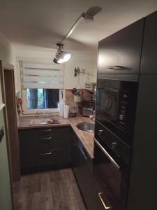a kitchen with a sink and a stove top oven at Bubi Niedlich in Thale