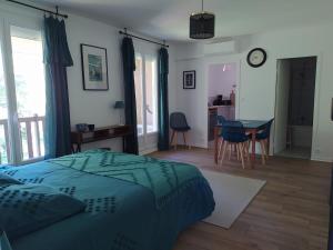 a bedroom with a bed and a table and a kitchen at studioleyme in Leyme