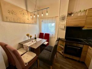 a kitchen with a table and a dining room at Apartment in Dramalj 44160 in Dramalj