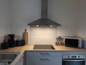 a kitchen with a stove top oven next to a sink at studioleyme in Leyme +8 photos