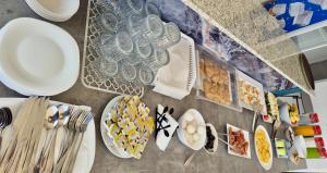 a table with plates of food on top of it at Galaxy Hotel in Ksamil