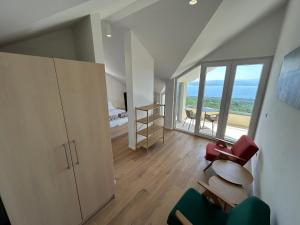 a living room with a large window and a bedroom at Villa in a quiet area - Private Pool - Sport - Starlink - BBQ in Baška Voda +48 photos