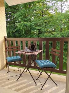 a table and two chairs sitting on a porch at studioleyme in Leyme